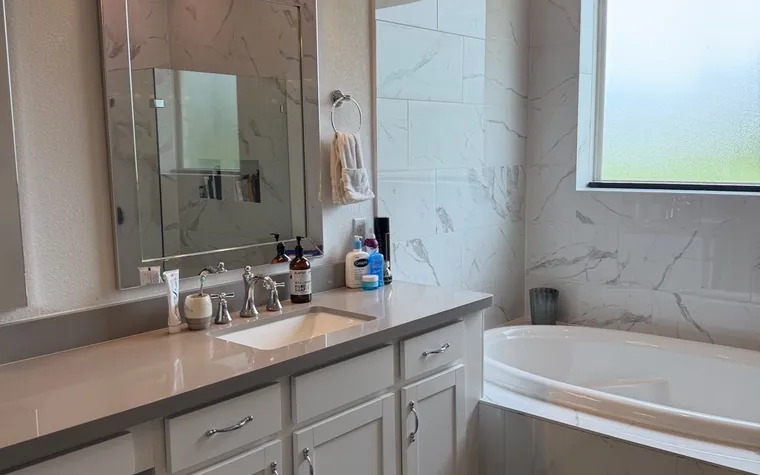 Marble bathroom vanity and tub after a deep clean